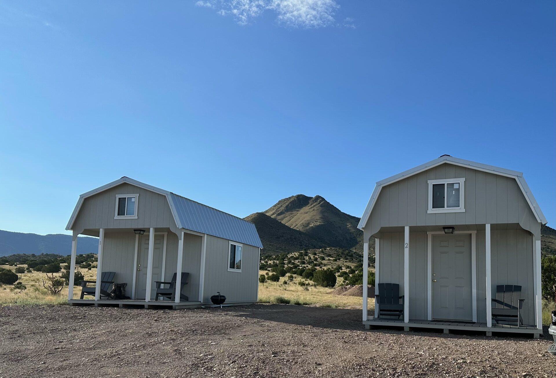LOH Outfitters cabins near the Magdalena lodge with a mountain peak behind
